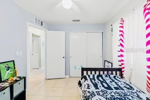 6656 Pinecrest Ln N, Pinellas Park, FL 33781 - tiled bedroom featuring a closet and a ceiling fan