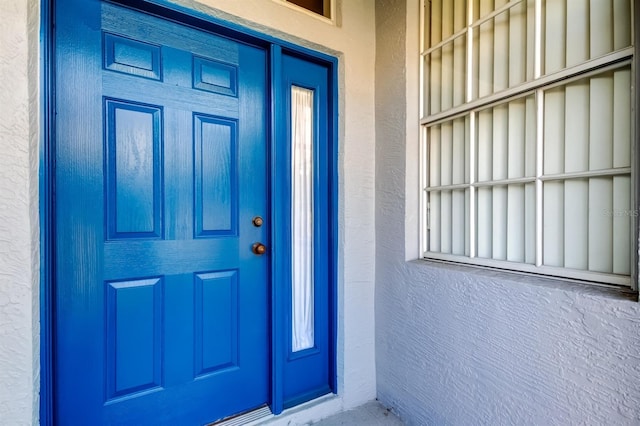 14466 Tamarind Loop, Spring Hill, FL 34609 - doorway to property with stucco siding