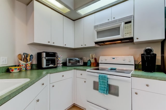 14466 Tamarind Loop, Spring Hill, FL 34609 - kitchen with white appliances, white cabinetry, and a sink