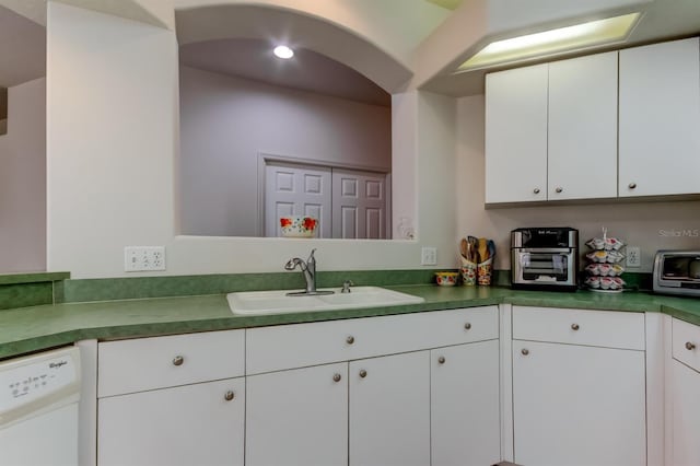 14466 Tamarind Loop, Spring Hill, FL 34609 - kitchen with a sink, white dishwasher, and white cabinets