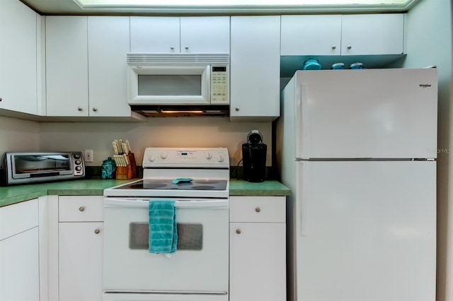 14466 Tamarind Loop, Spring Hill, FL 34609 - kitchen featuring white appliances and white cabinetry