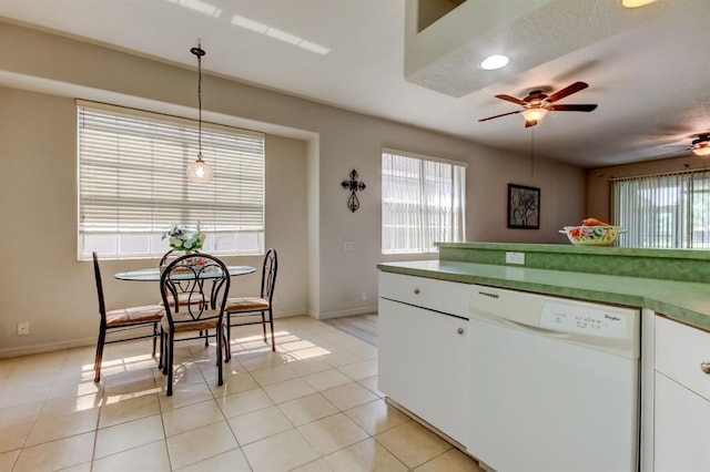 14466 Tamarind Loop, Spring Hill, FL 34609 - kitchen featuring white dishwasher, ceiling fan, decorative light fixtures, white cabinets, and baseboards