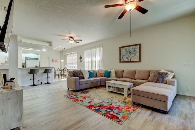 14466 Tamarind Loop, Spring Hill, FL 34609 - living room with a ceiling fan, wood finished floors, and a textured ceiling