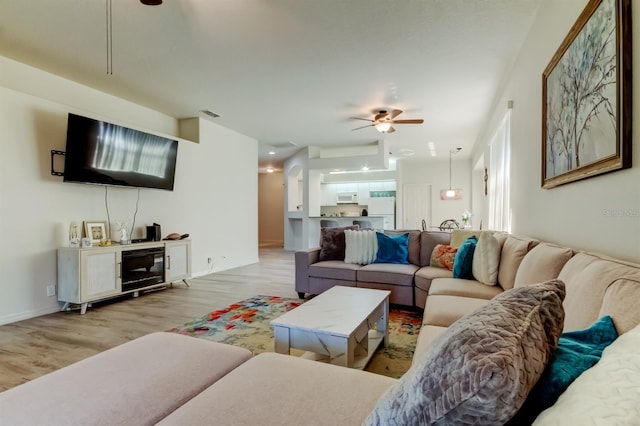 14466 Tamarind Loop, Spring Hill, FL 34609 - living area featuring wood finished floors and a ceiling fan