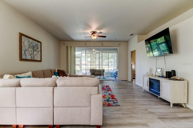 14466 Tamarind Loop, Spring Hill, FL 34609 - living room featuring light wood-type flooring, ceiling fan, and baseboards