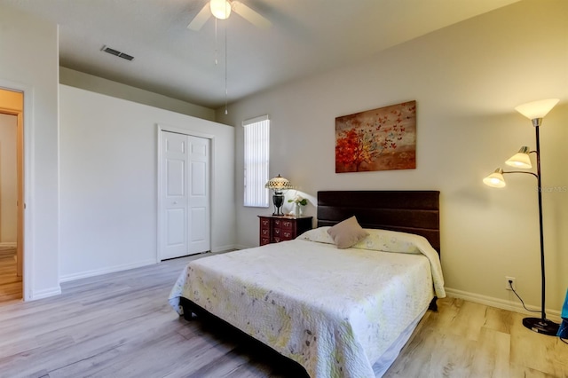 14466 Tamarind Loop, Spring Hill, FL 34609 - bedroom with wood finished floors, a closet, baseboards, and a ceiling fan