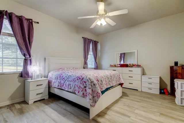 14466 Tamarind Loop, Spring Hill, FL 34609 - bedroom featuring light wood finished floors and ceiling fan
