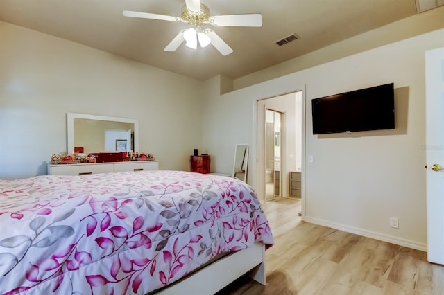 14466 Tamarind Loop, Spring Hill, FL 34609 - bedroom with light wood-style floors, ensuite bathroom, baseboards, and ceiling fan
