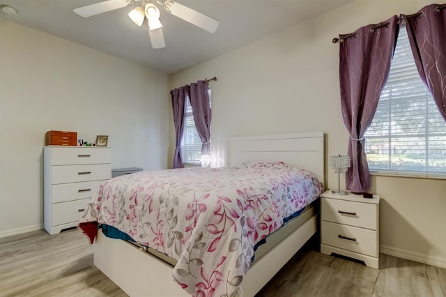 14466 Tamarind Loop, Spring Hill, FL 34609 - bedroom featuring wood finished floors, baseboards, and a ceiling fan
