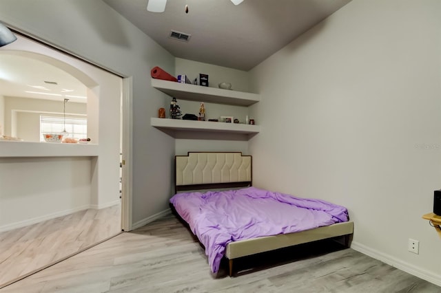 14466 Tamarind Loop, Spring Hill, FL 34609 - bedroom featuring wood finished floors, baseboards, ceiling fan, and arched walkways
