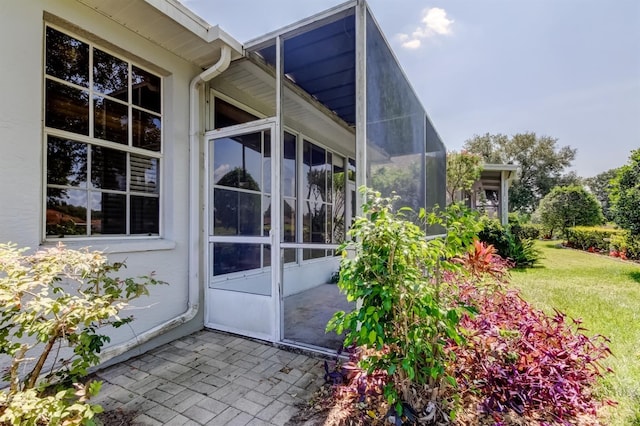 14466 Tamarind Loop, Spring Hill, FL 34609 - doorway to property featuring a patio and a yard