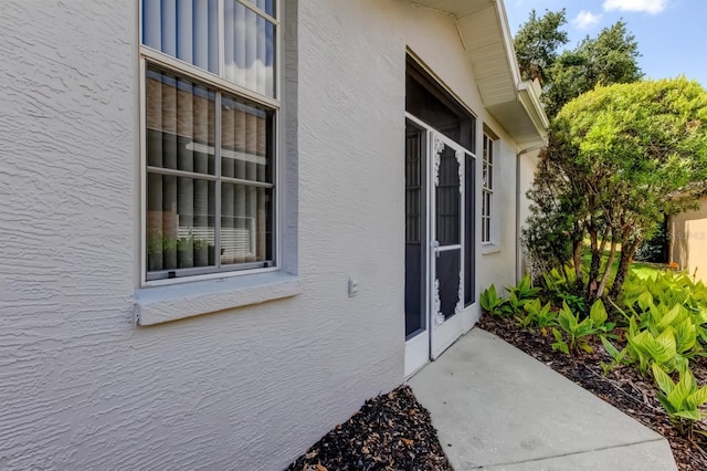 14466 Tamarind Loop, Spring Hill, FL 34609 - doorway to property with stucco siding