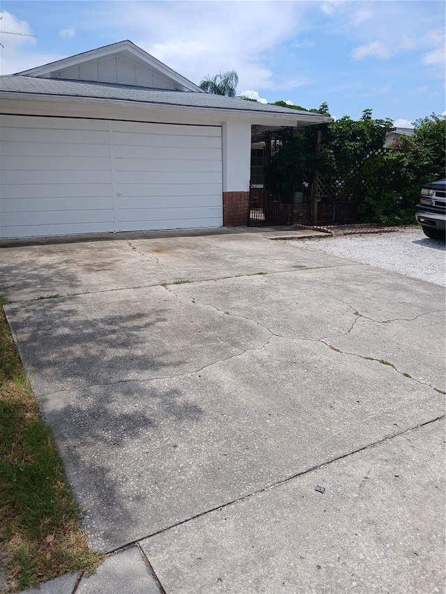 9516 Glen Moor Ln, Port Richey, FL 34668 - view of front of house with brick siding, driveway, and board and batten siding