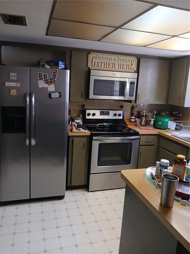 9516 Glen Moor Ln, Port Richey, FL 34668 - kitchen featuring appliances with stainless steel finishes, light floors, and light countertops