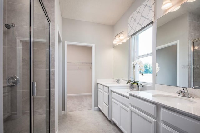 1681 W Palms Dr, Port Charlotte, FL 33953 - bathroom featuring a stall shower, double vanity, a spacious closet, and tile patterned floors