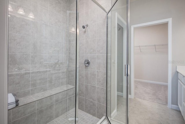 1681 W Palms Dr, Port Charlotte, FL 33953 - full bathroom with a stall shower, vanity, a walk in closet, and tile patterned floors