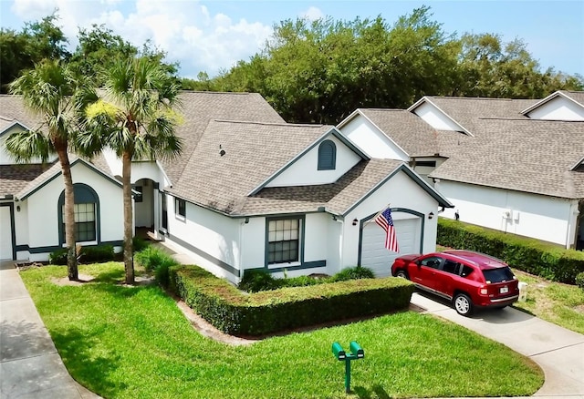 9200 Turnberry Ct, New Port Richey, FL 34655 - view of front of property with driveway, stucco siding, roof with shingles, and an attached garage