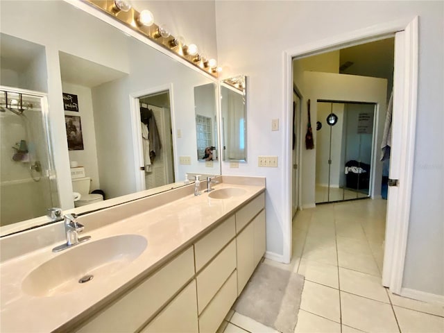 9200 Turnberry Ct, New Port Richey, FL 34655 - full bathroom featuring toilet, tile patterned floors, double vanity, baseboards, and an enclosed shower