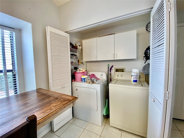 9200 Turnberry Ct, New Port Richey, FL 34655 - laundry area with washing machine and dryer, cabinet space, and light tile patterned flooring