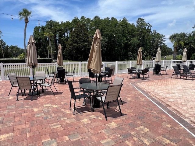 9200 Turnberry Ct, New Port Richey, FL 34655 - view of patio / terrace featuring outdoor dining area and view of scattered trees
