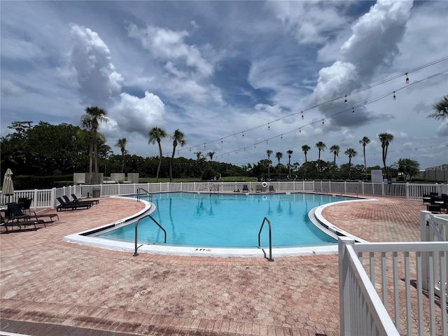 9200 Turnberry Ct, New Port Richey, FL 34655 - community pool featuring a patio