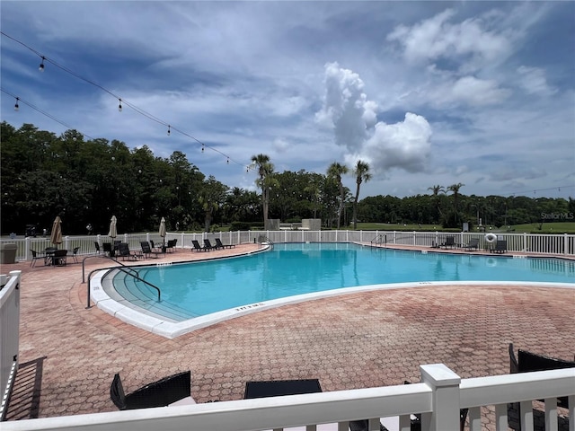 9200 Turnberry Ct, New Port Richey, FL 34655 - community pool featuring a patio area