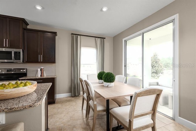 1723 W Palms Dr, Port Charlotte, FL 33953 - dining space featuring baseboards, recessed lighting, and light tile patterned flooring