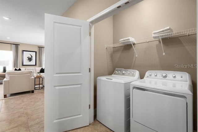 1723 W Palms Dr, Port Charlotte, FL 33953 - laundry area featuring separate washer and dryer and light tile patterned floors