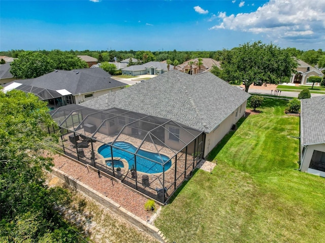 13248 Linzia Ln, Spring Hill, FL 34609 - view of pool with a patio, a pool with connected hot tub, a residential view, a lawn, and a lanai