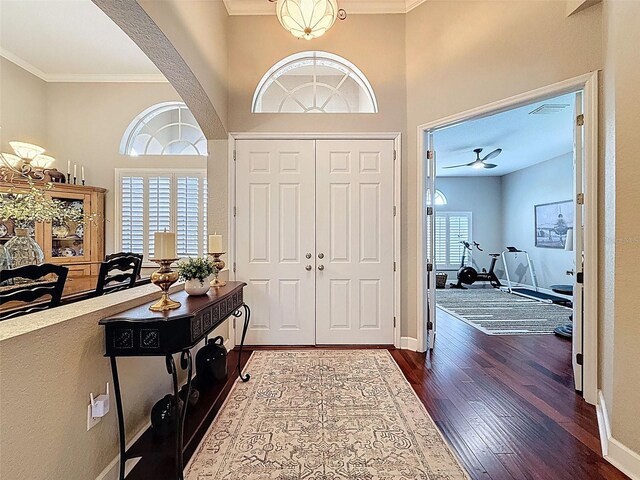 13248 Linzia Ln, Spring Hill, FL 34609 - entryway featuring crown molding, dark wood-type flooring, baseboards, arched walkways, and a ceiling fan