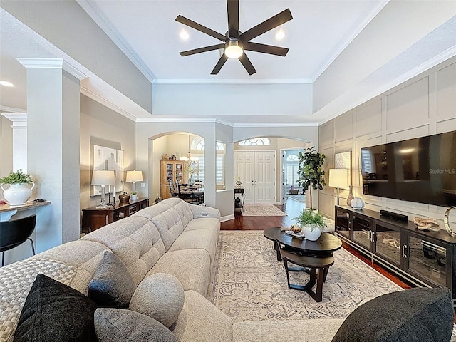 13248 Linzia Ln, Spring Hill, FL 34609 - living area featuring arched walkways, a ceiling fan, crown molding, wood finished floors, and ornate columns
