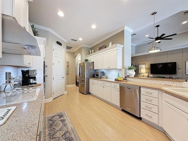 13248 Linzia Ln, Spring Hill, FL 34609 - kitchen with stainless steel appliances, wall chimney range hood, crown molding, backsplash, and ceiling fan