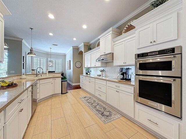 13248 Linzia Ln, Spring Hill, FL 34609 - kitchen featuring stainless steel appliances, ornamental molding, under cabinet range hood, recessed lighting, and white cabinets