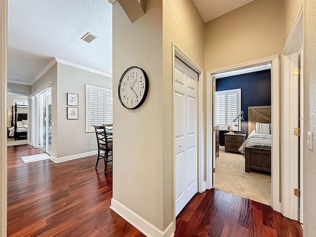 13248 Linzia Ln, Spring Hill, FL 34609 - hallway featuring a textured wall, dark wood finished floors, crown molding, and baseboards