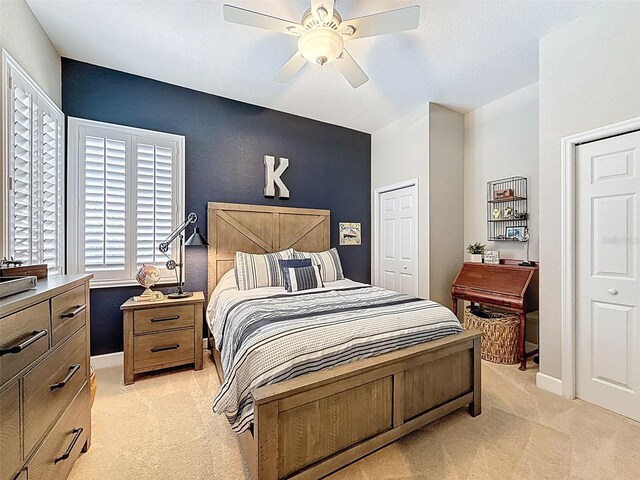 13248 Linzia Ln, Spring Hill, FL 34609 - bedroom with light carpet, baseboards, a ceiling fan, and a closet