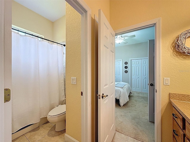 13248 Linzia Ln, Spring Hill, FL 34609 - bathroom featuring tile patterned flooring, vanity, toilet, a textured wall, and a ceiling fan