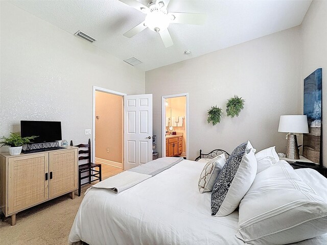 13248 Linzia Ln, Spring Hill, FL 34609 - bedroom with light carpet, a ceiling fan, and ensuite bathroom
