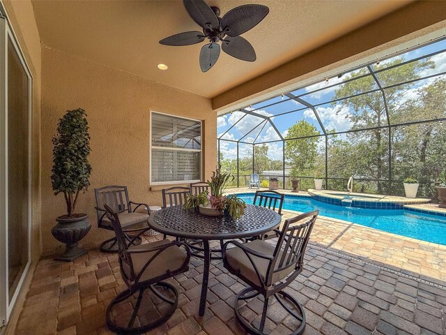 13248 Linzia Ln, Spring Hill, FL 34609 - view of patio / terrace with a lanai, ceiling fan, and a pool with connected hot tub