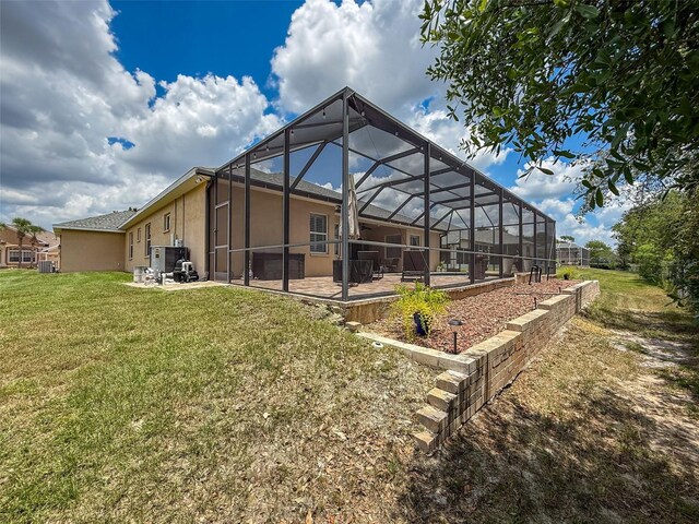 13248 Linzia Ln, Spring Hill, FL 34609 - rear view of house with a patio, a yard, stucco siding, and a lanai