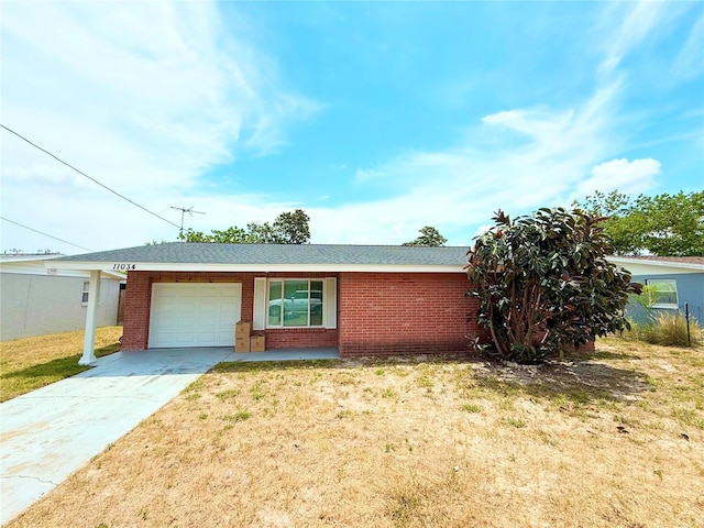 11034 Harding Dr, Port Richey, FL 34668 - ranch-style home featuring a garage, brick siding, and concrete driveway