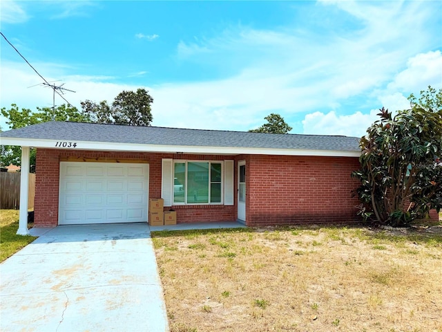 11034 Harding Dr, Port Richey, FL 34668 - single story home with an attached garage, brick siding, and driveway