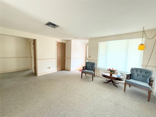11034 Harding Dr, Port Richey, FL 34668 - sitting room with light colored carpet and a textured ceiling