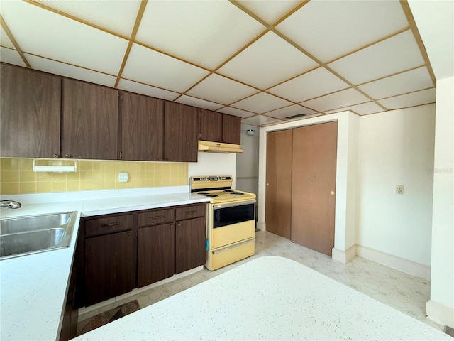 11034 Harding Dr, Port Richey, FL 34668 - kitchen with white range with electric stovetop, under cabinet range hood, a sink, light countertops, and backsplash