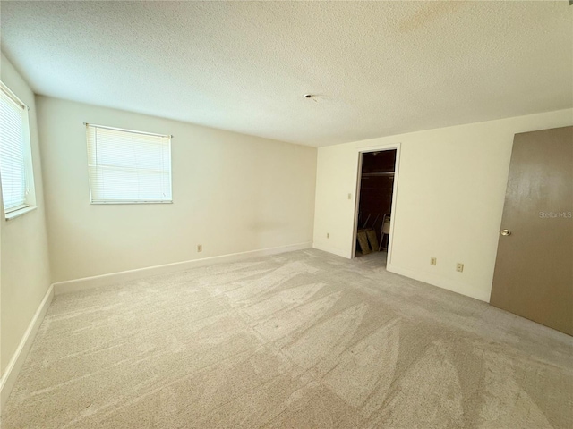 11034 Harding Dr, Port Richey, FL 34668 - unfurnished room with light colored carpet, healthy amount of natural light, and a textured ceiling