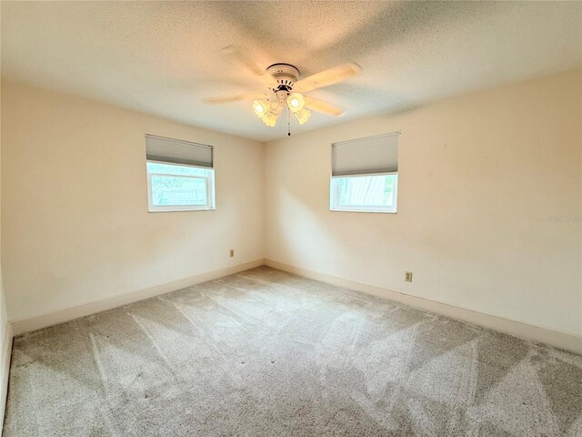11034 Harding Dr, Port Richey, FL 34668 - carpeted empty room featuring ceiling fan, baseboards, and a textured ceiling