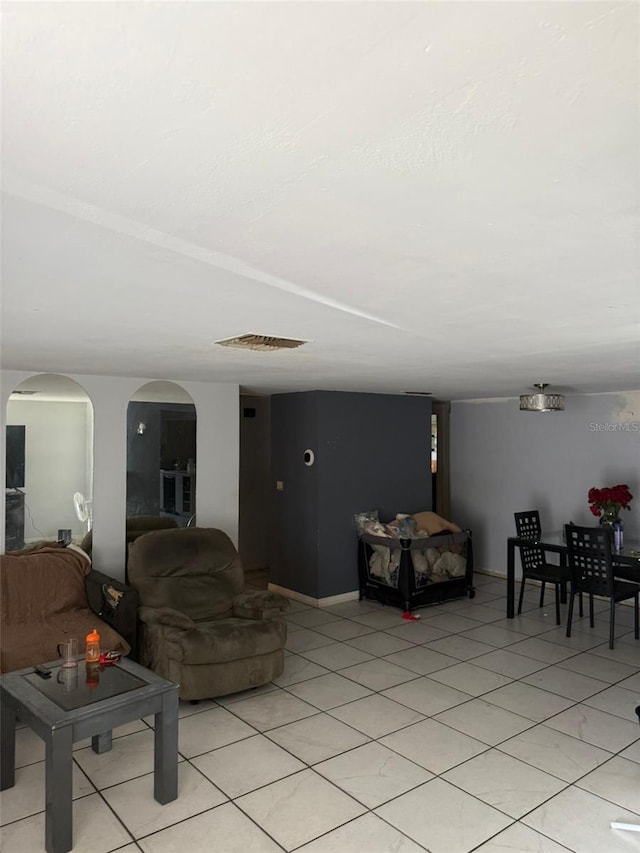 11726 Oceanside Dr, Port Richey, FL 34668 - living area featuring arched walkways and light tile patterned floors