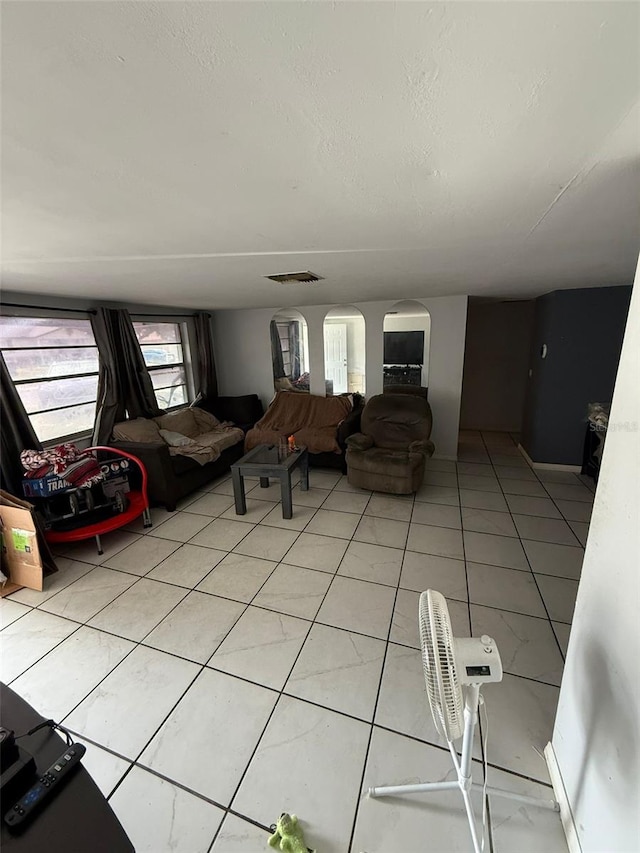 11726 Oceanside Dr, Port Richey, FL 34668 - living room featuring light tile patterned floors and a textured ceiling
