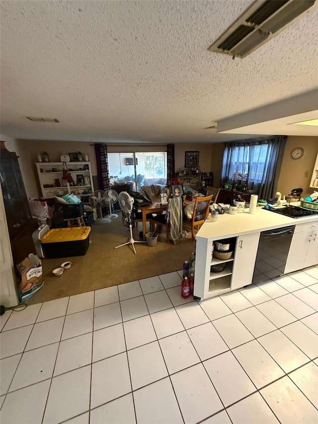 11726 Oceanside Dr, Port Richey, FL 34668 - kitchen with dishwasher, a textured ceiling, open shelves, light carpet, and light tile patterned floors