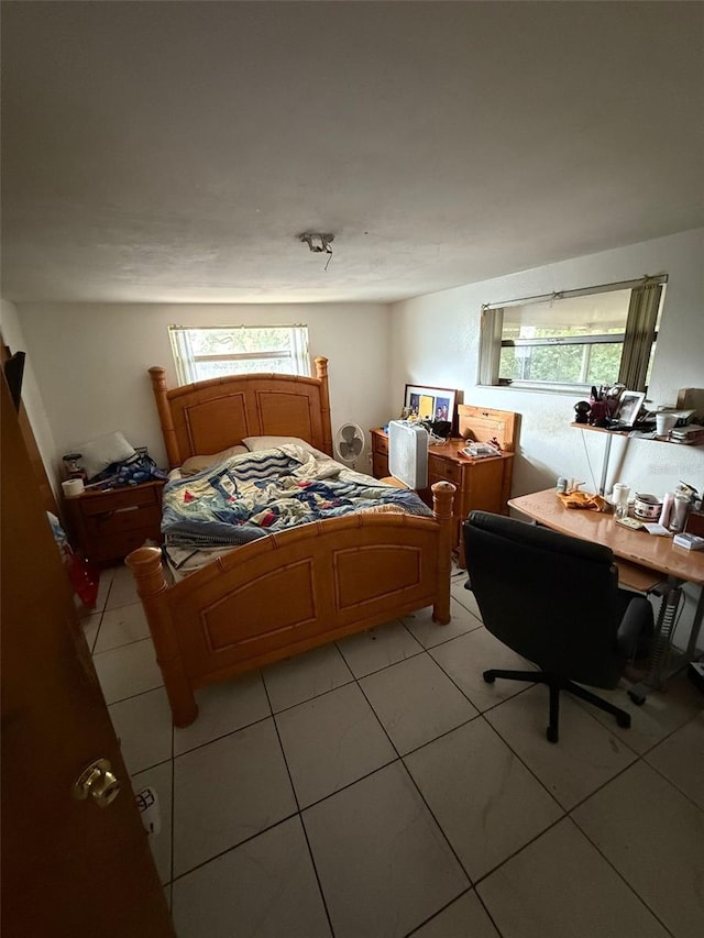 11726 Oceanside Dr, Port Richey, FL 34668 - bedroom with multiple windows, light tile patterned floors, and an office area
