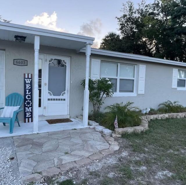 6603 Adams St, New Port Richey, FL 34652 - property entrance with stucco siding and covered porch